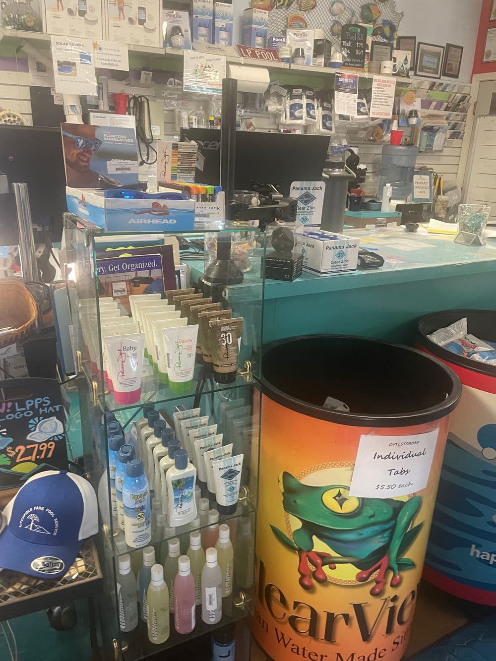 Display of various skincare products and accessories at a retail counter.